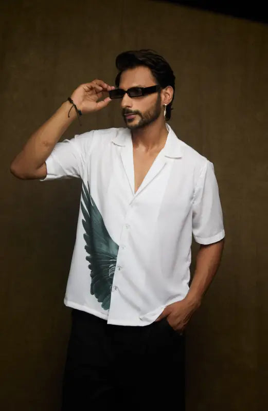 Person wearing a Crest Feather Print shirt with digital design and sunglasses