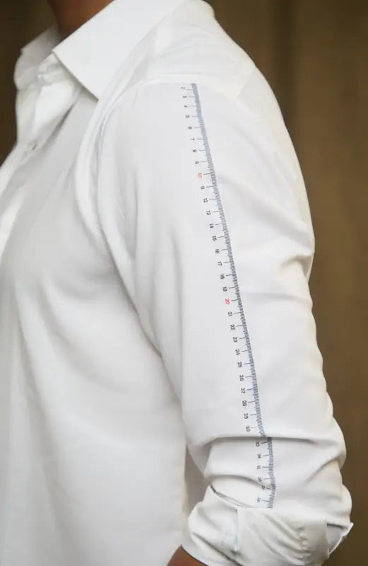 White dress shirt featuring a distinctive design with measurement tape sleeve print